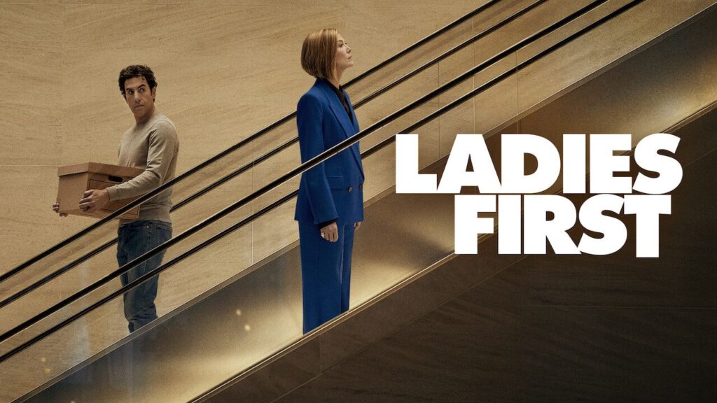 Ladies First Netflix film official scene man holding box woman in blue suit escalator drama film