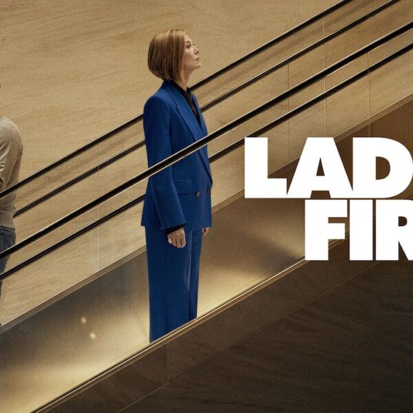 Ladies First Netflix film official scene man holding box woman in blue suit escalator drama film